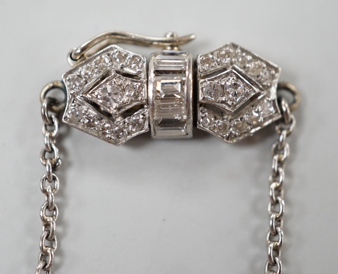 An early to mid 20th century white metal, baguette and round cut diamond set clasp chain, approx. 38cm (knot), gross weight 7.4 grams.